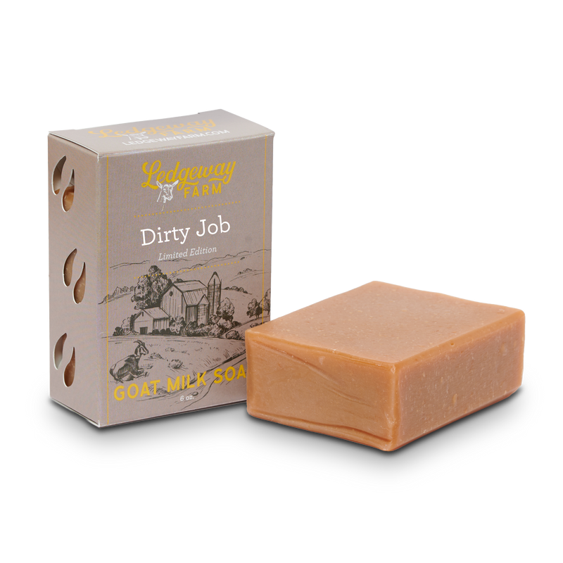 Bar of goat milk soap with packaging labeled 'Dirty Job' on a white background