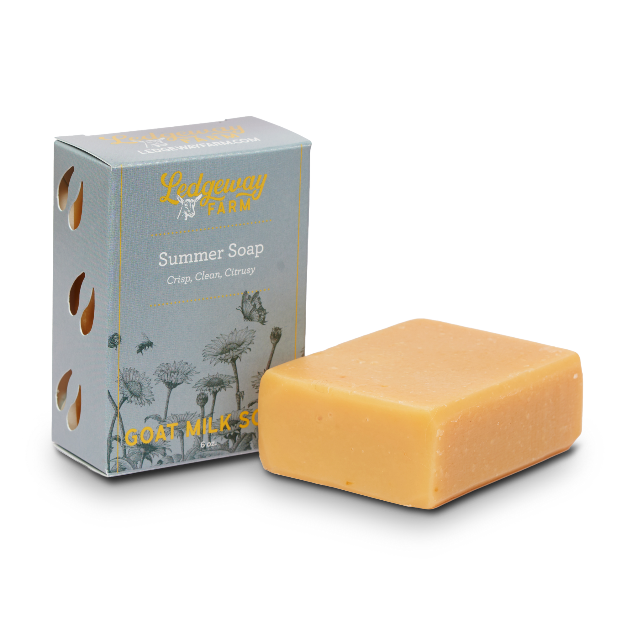 Bar of summer goat milk soap and its packaging on a white background