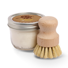 Jar of dish soap and wooden brush on a white background