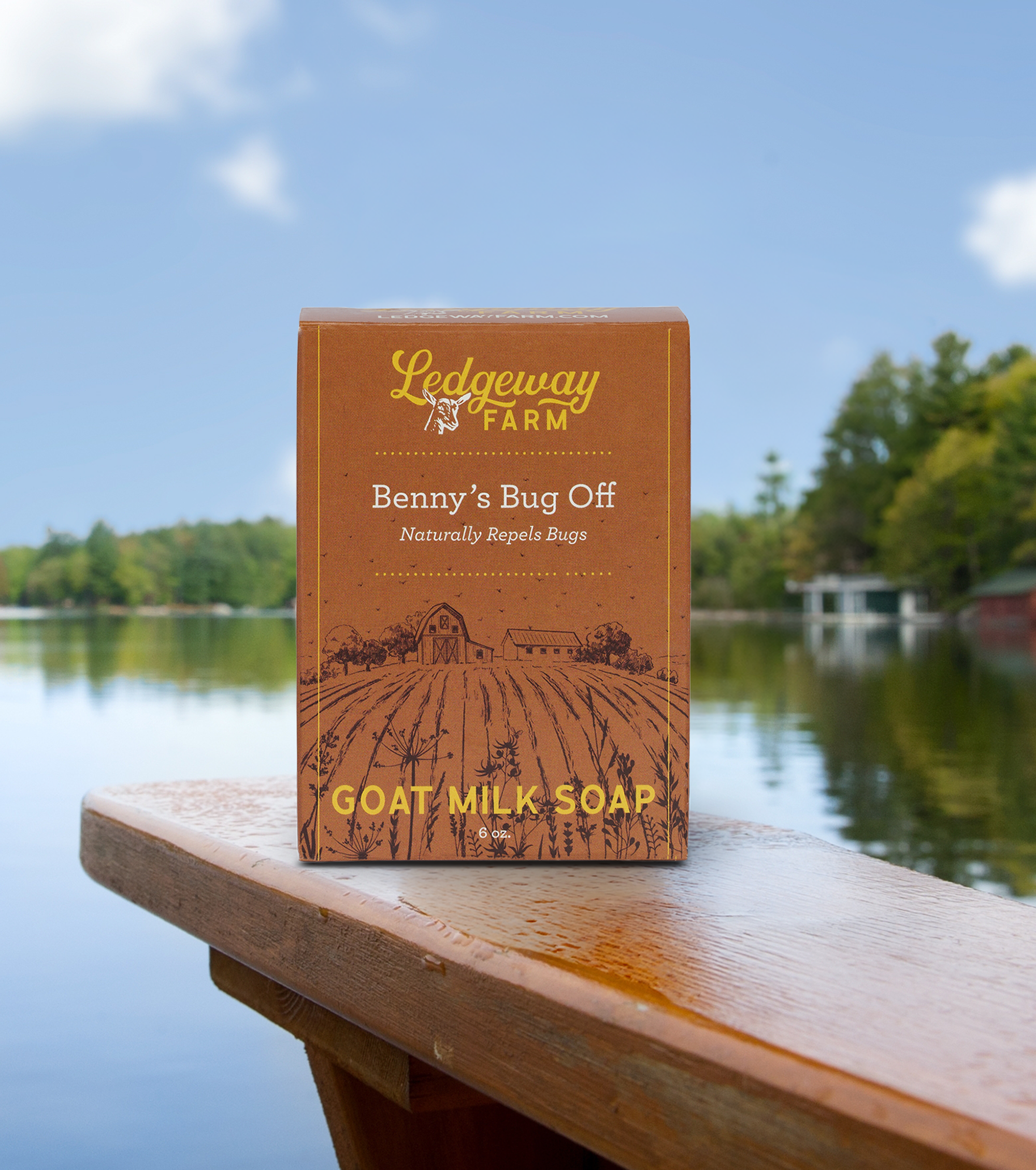 Ledgeway Farm goat milk soap packaging on a wooden ledge with a lake and trees in the background