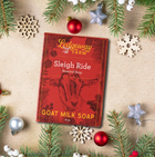 Red soap packaging with goat illustration on a decorative background with Christmas elements