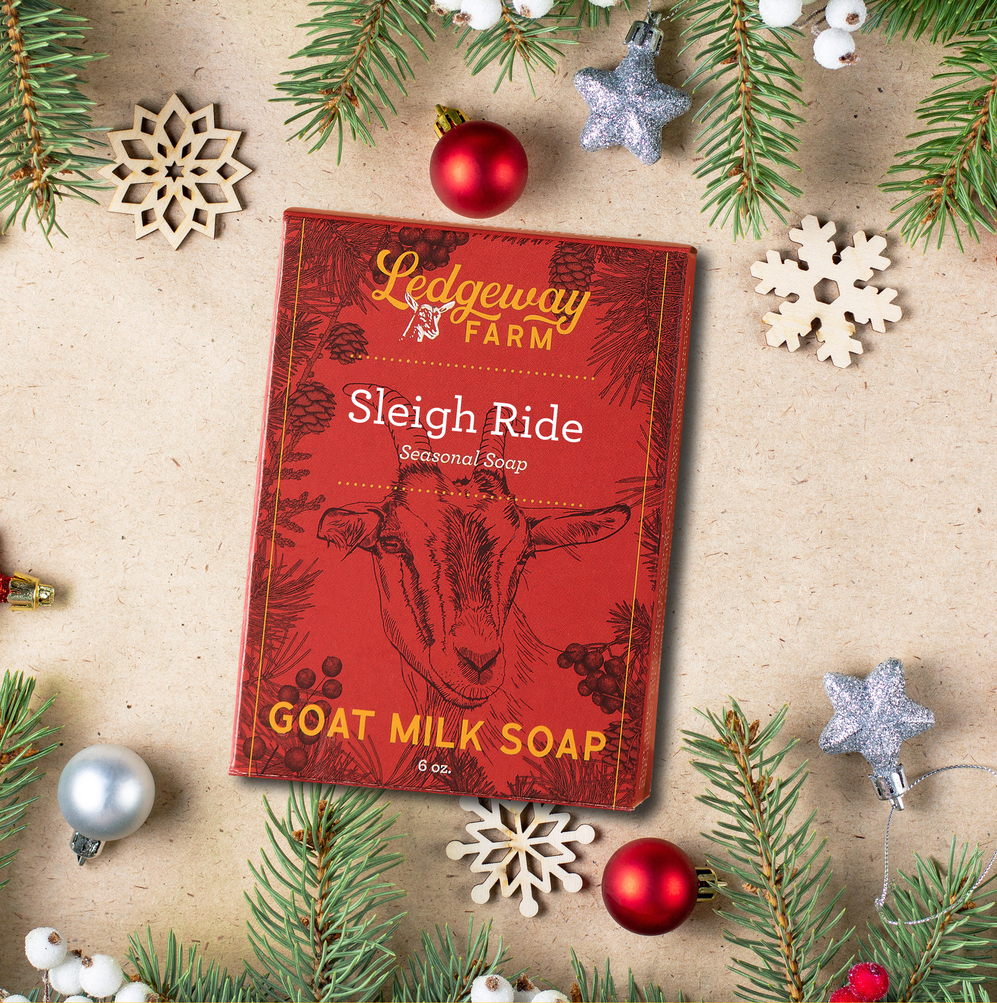 Red soap packaging with goat illustration on a decorative background with Christmas elements
